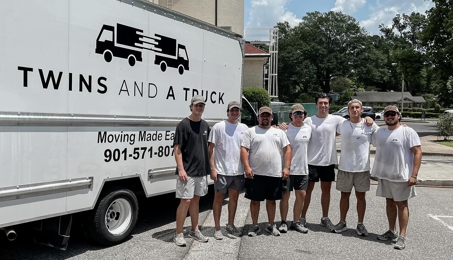 The Twins and a Truck crew standing in front of their branded moving truck in Memphis