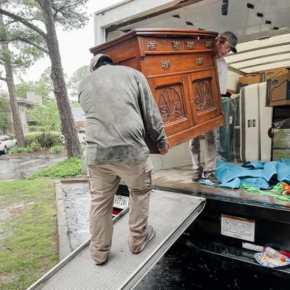 Twins and a Truck crew loading an antique wood sideboard into the truck